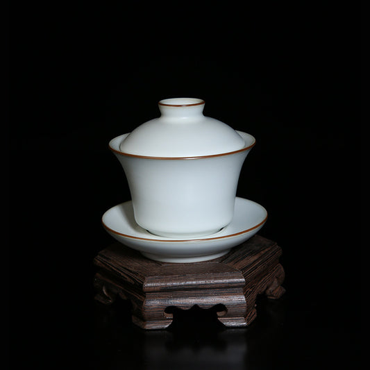 The picture of the tea bowl with moon-white glaze of Ru Kiln. The tea bowl has a simple and elegant shape, with an open mouth, a curved belly and a small circular foot. The lines are smooth and natural. The moon-white glaze evenly covers the inner and outer walls of the bowl. The glaze surface is smooth and delicate, like fat or jade, giving people a warm, smooth and mellow texture. 