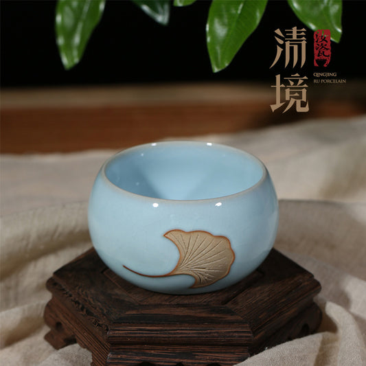 A Ru porcelain tea cup with sky-blue glaze. The body of the cup is in an elegant cylindrical shape with smooth lines. The whole cup is covered by the light and elegant sky-blue glaze, fully demonstrating a primitive and classic charm. 