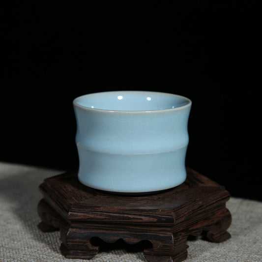 A Ru porcelain tea cup with sky-blue glaze. The body of the cup is in an elegant bamboo shape with smooth lines. The whole cup is covered by the light and elegant sky-blue glaze, fully showing a primitive and classic charm. 