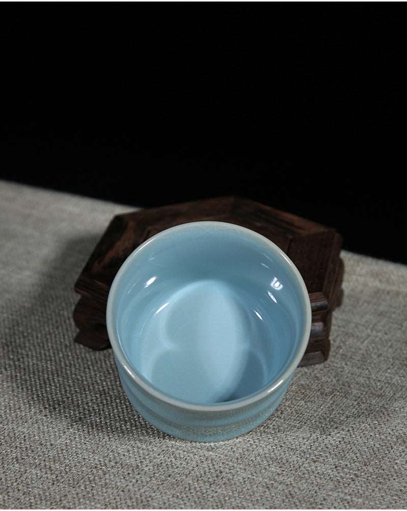 A Ru porcelain tea cup with sky-blue glaze. The body of the cup is in an elegant bamboo shape with smooth lines. The whole cup is covered by the light and elegant sky-blue glaze, fully showing a primitive and classic charm. 